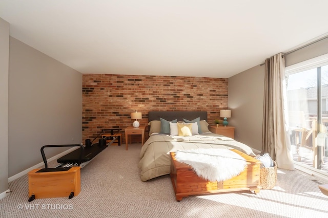 bedroom with light carpet, access to exterior, and brick wall