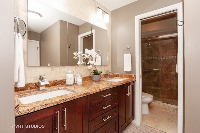 bathroom featuring decorative backsplash, tile patterned flooring, vanity, toilet, and a shower with door