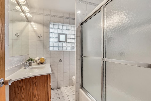 4850 N Crescent Ave, Norridge, IL 60706 - bathroom featuring tile walls, toilet, tile patterned flooring, and vanity