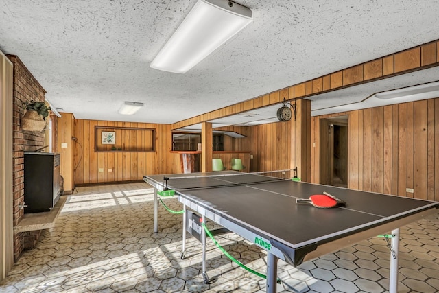 4850 N Crescent Ave, Norridge, IL 60706 - recreation room featuring a fireplace, wooden walls, a textured ceiling, and light floors