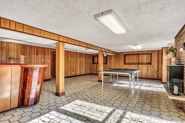 4850 N Crescent Ave, Norridge, IL 60706 - playroom with a dry bar, light floors, a textured ceiling, baseboards, and wooden walls