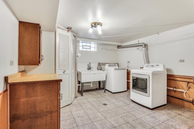 4850 N Crescent Ave, Norridge, IL 60706 - washroom featuring washer and clothes dryer, light tile patterned flooring, a sink, and cabinet space