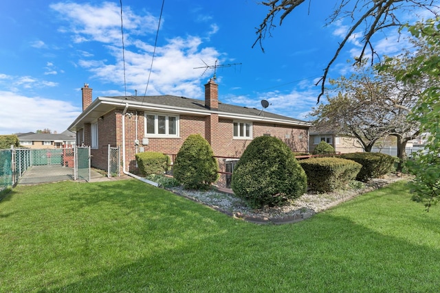 4850 N Crescent Ave, Norridge, IL 60706 - rear view of house featuring a lawn, brick siding, a chimney, and fence