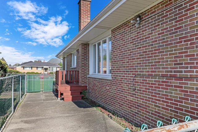 4850 N Crescent Ave, Norridge, IL 60706 - view of side of home featuring brick siding, fence, and a chimney