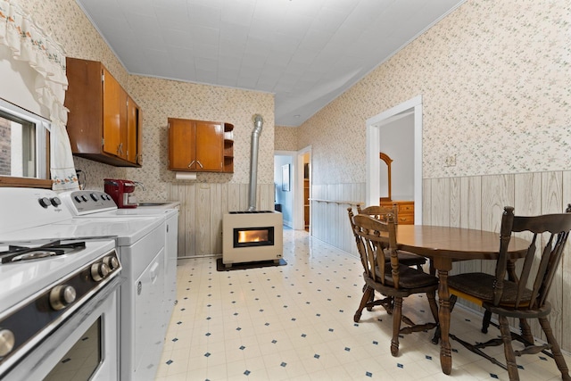 kitchen with washer and dryer, a wood stove, and white range