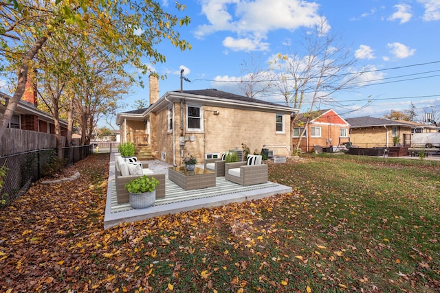 back of house featuring a yard and an outdoor hangout area