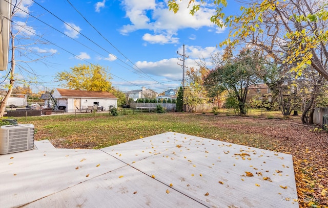 view of yard featuring central AC unit and a patio