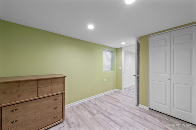 unfurnished bedroom featuring light hardwood / wood-style floors and a closet