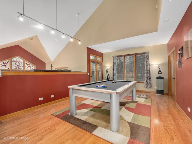 game room with pool table, light hardwood / wood-style flooring, and high vaulted ceiling