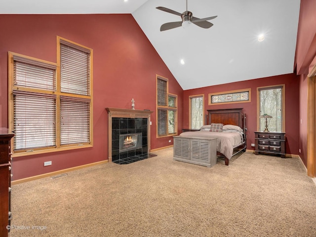 carpeted bedroom with a fireplace, high vaulted ceiling, and ceiling fan