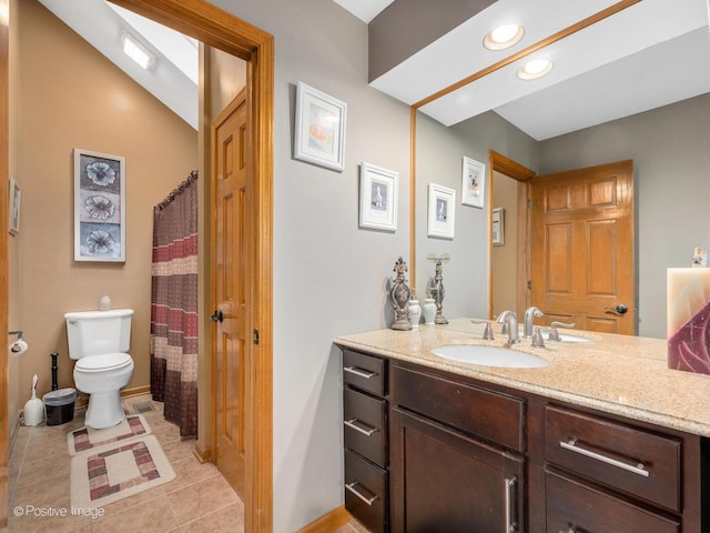 bathroom featuring vaulted ceiling, vanity, toilet, and tile patterned flooring