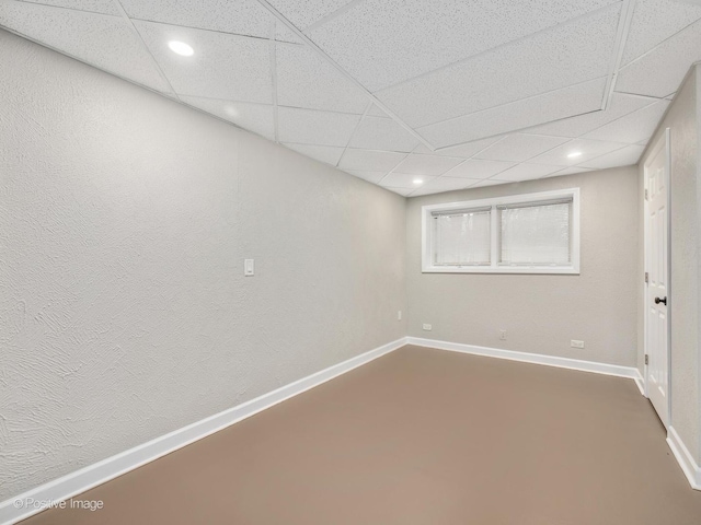 basement with a paneled ceiling