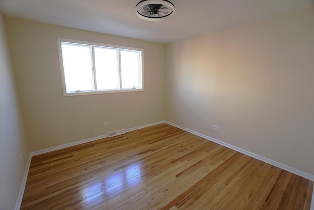 spare room with light hardwood / wood-style flooring