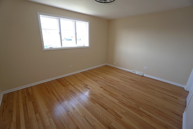 unfurnished room with light hardwood / wood-style flooring