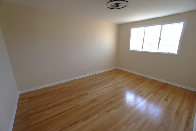 spare room featuring light wood-type flooring