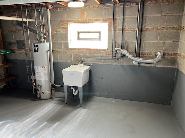 utility room featuring sink and water heater