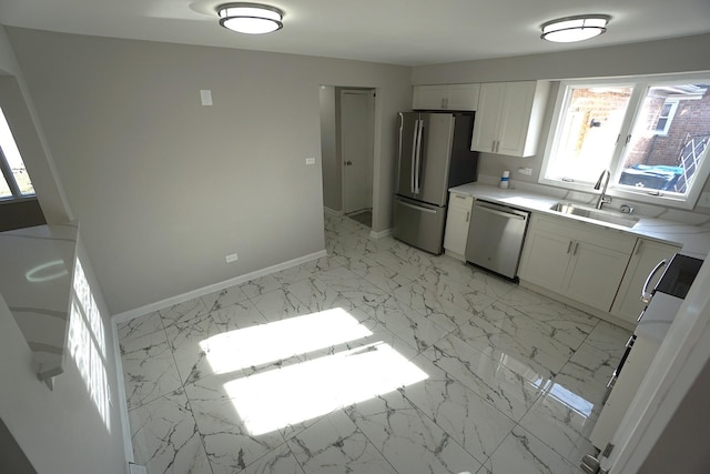 kitchen featuring sink, white cabinets, and stainless steel appliances