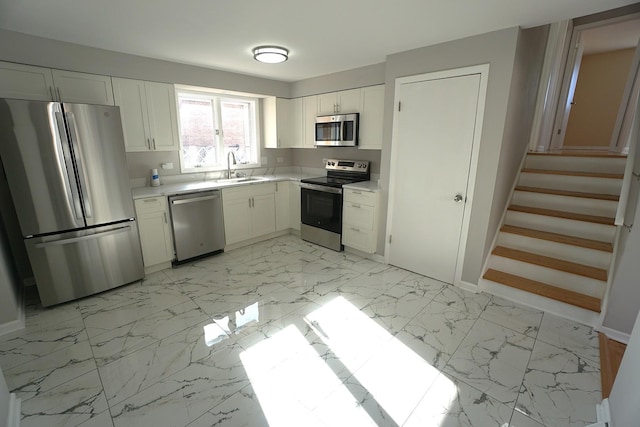 kitchen with sink, white cabinetry, and appliances with stainless steel finishes