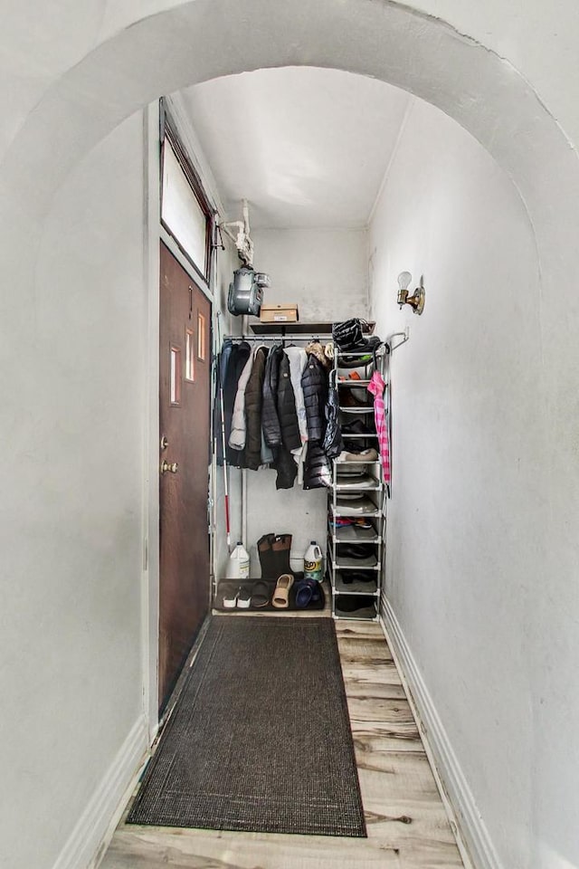 walk in closet with hardwood / wood-style flooring