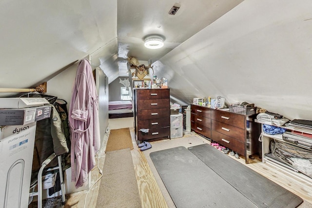 walk in closet with vaulted ceiling