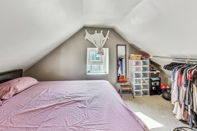 bedroom featuring vaulted ceiling and carpet