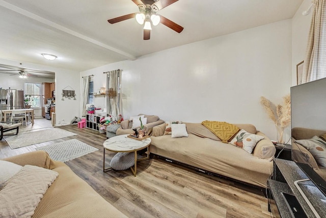 living room featuring beam ceiling, ceiling fan, and hardwood / wood-style floors