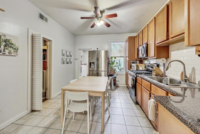 kitchen featuring ceiling fan, appliances with stainless steel finishes, sink, backsplash, and light tile patterned floors