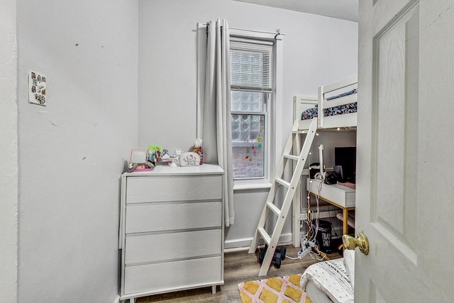 bedroom with dark wood-type flooring