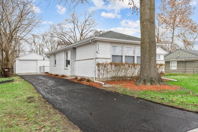 view of home's exterior with a lawn, an outbuilding, and a garage