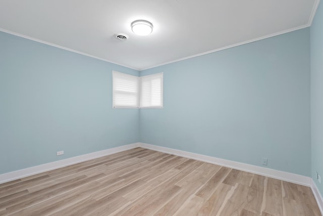 empty room with light hardwood / wood-style floors and ornamental molding