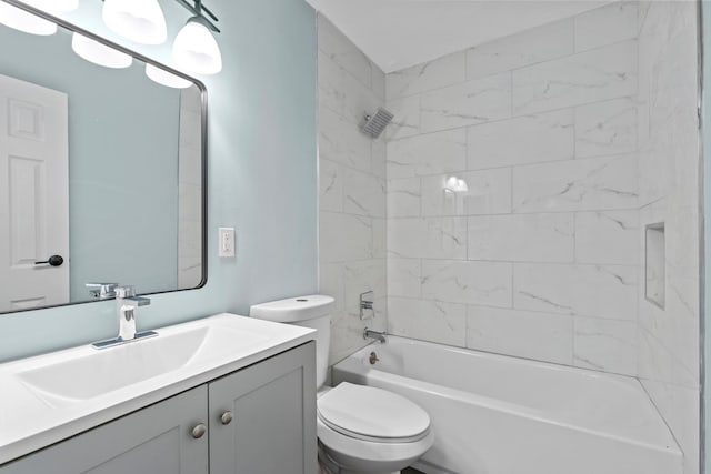 full bathroom with toilet, vanity, and tiled shower / bath