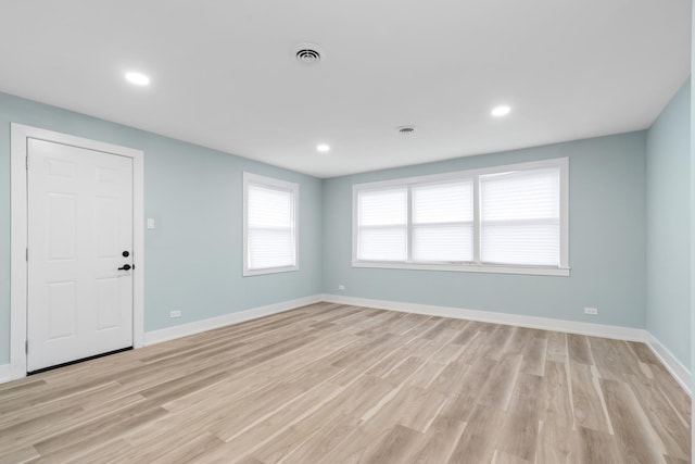 spare room featuring light wood-type flooring