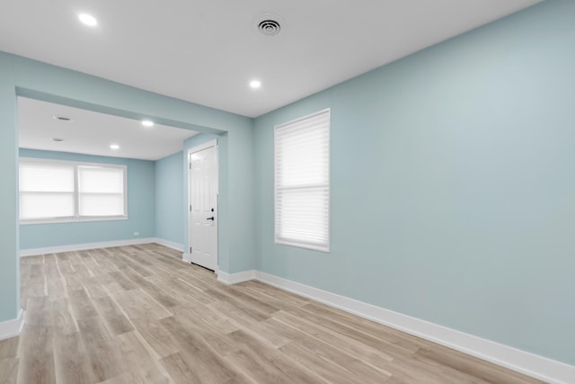 spare room with plenty of natural light and light wood-type flooring