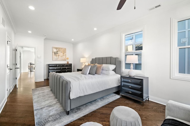 bedroom featuring dark hardwood / wood-style flooring, crown molding, and ceiling fan