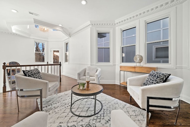 sitting room with crown molding and dark wood-type flooring