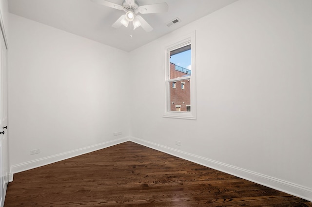 empty room with dark hardwood / wood-style floors and ceiling fan