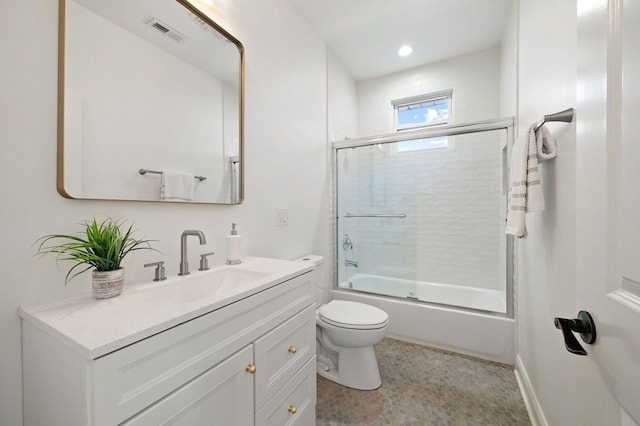 full bathroom with vanity, combined bath / shower with glass door, and toilet