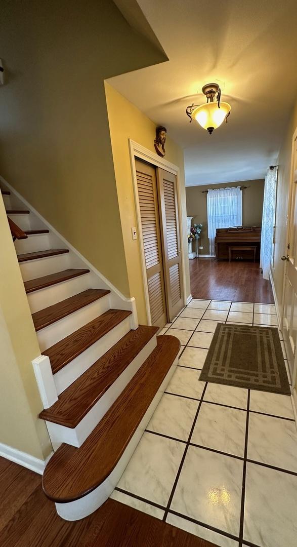 stairs with tile patterned floors