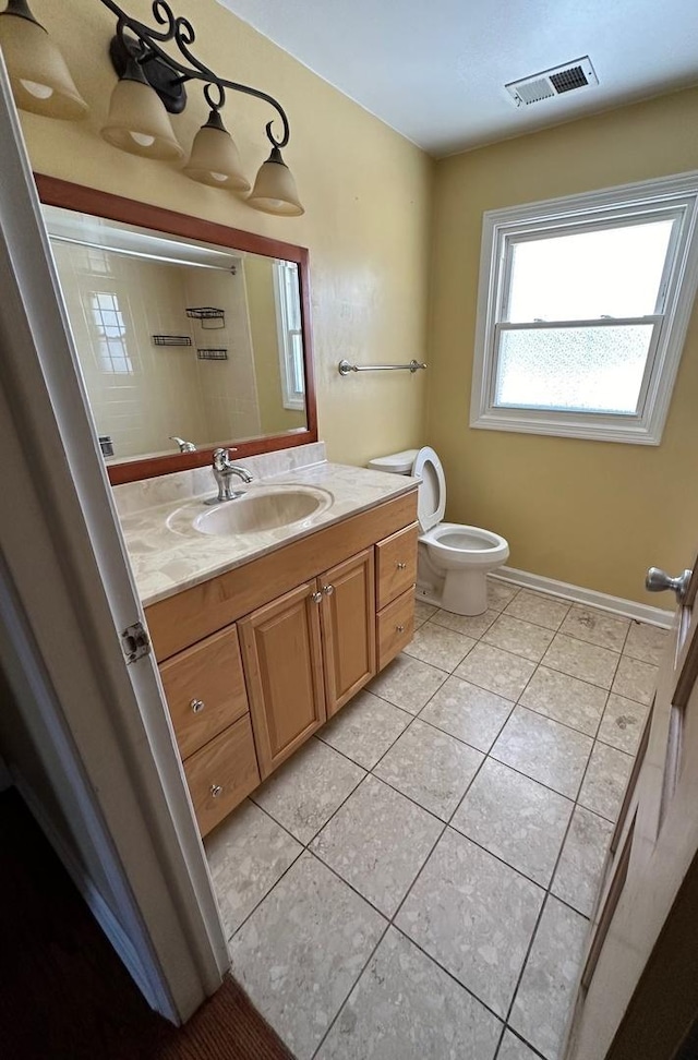 bathroom with vanity, tile patterned floors, and toilet