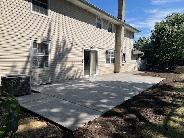 rear view of property with central AC and a patio area