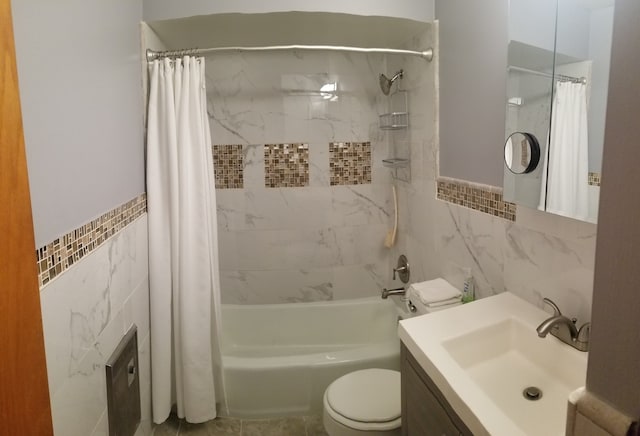 full bathroom featuring tile walls, vanity, toilet, and shower / bathtub combination with curtain