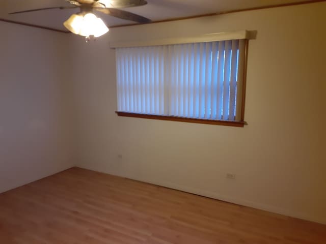 spare room with ceiling fan and hardwood / wood-style floors