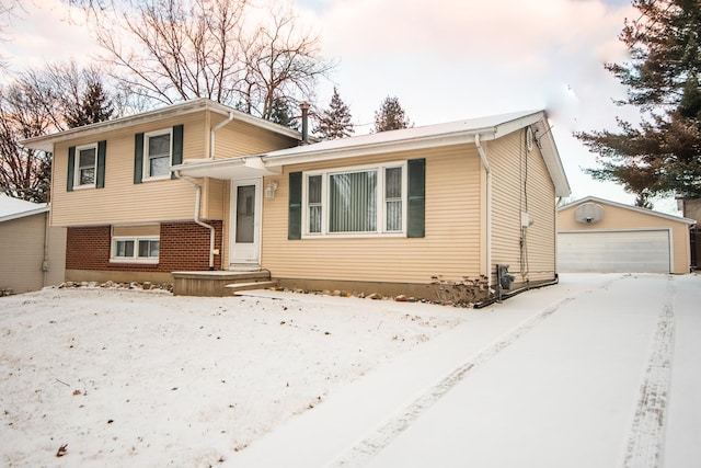 tri-level home featuring an outbuilding and a garage