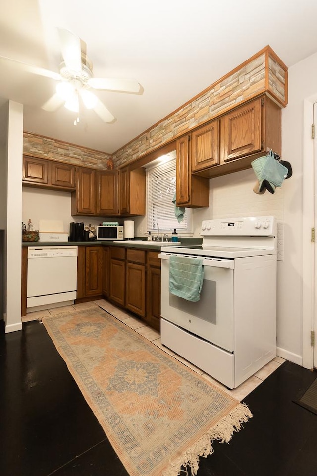 kitchen featuring sink, white appliances, and ceiling fan