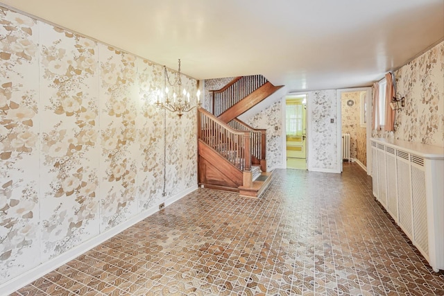 empty room with radiator and an inviting chandelier