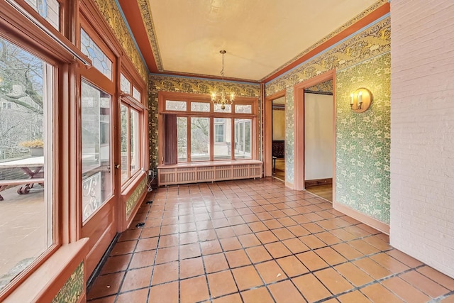 unfurnished sunroom with an inviting chandelier, radiator heating unit, and plenty of natural light