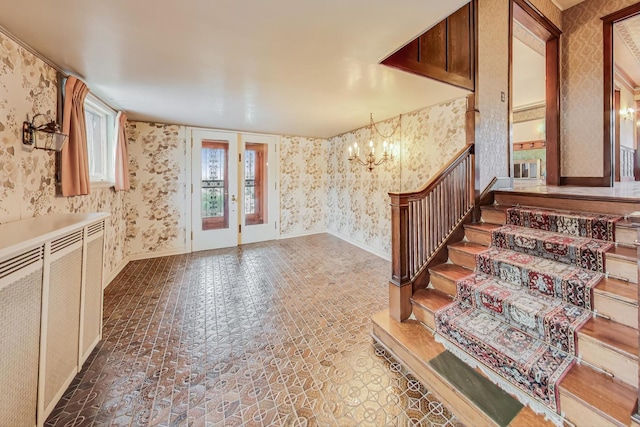 entrance foyer featuring an inviting chandelier