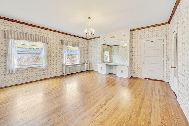 unfurnished living room featuring crown molding, a notable chandelier, hardwood / wood-style flooring, and radiator