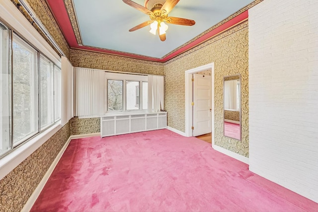 interior space featuring ceiling fan, radiator, carpet floors, and multiple windows