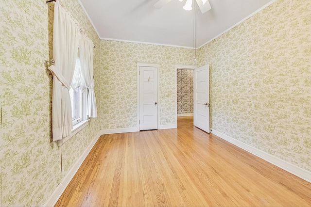 unfurnished bedroom featuring wood-type flooring, ornamental molding, and ceiling fan